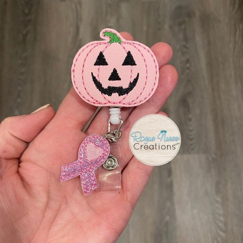 Matte Pink Pumpkin Retractable Badge Reel with a Pink Glitter Awareness Ribbon Dangle. Breast Cancer Awareness Badge Reel