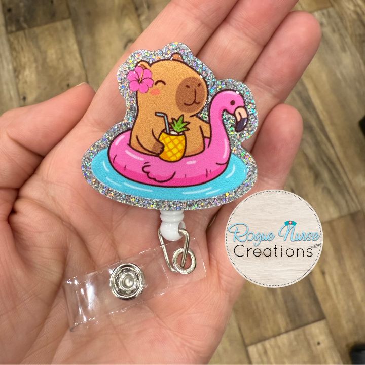 Capybara in a Pink Flamingo Floaty with a pineapple and a cute flower Retractable Badge Reel, UV Printed on Silver Glitter Acrylic