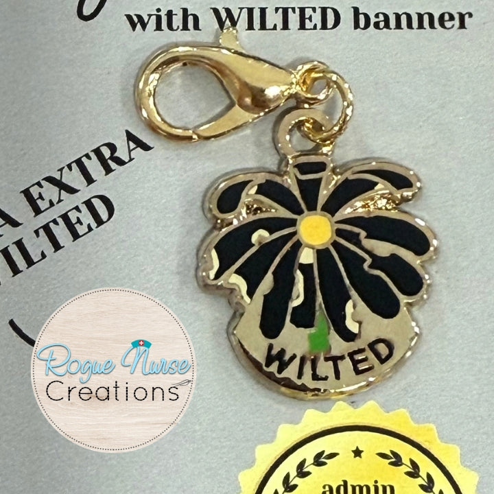 The Extra Extra WILTED Daisy Enamel Badge Charm For The Ordinary Nurse! YELLOW Center With Black Petals. WILTED Banner below design.