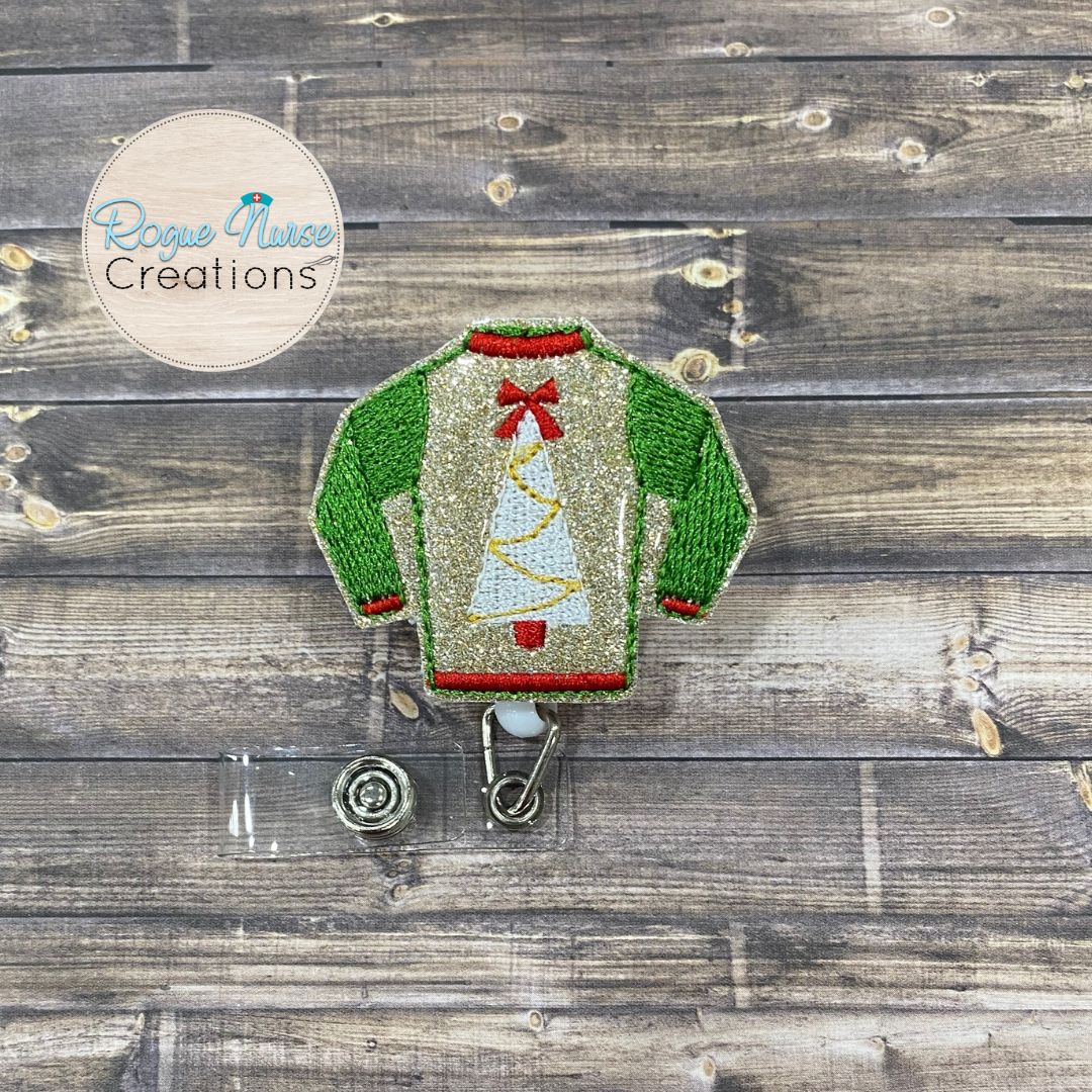 Holiday Sweater Retractable Badge Reel, Matte Red, Glitter Green or Glitter Gold Sweater with a White Holiday Tree and Textured Sleeves.