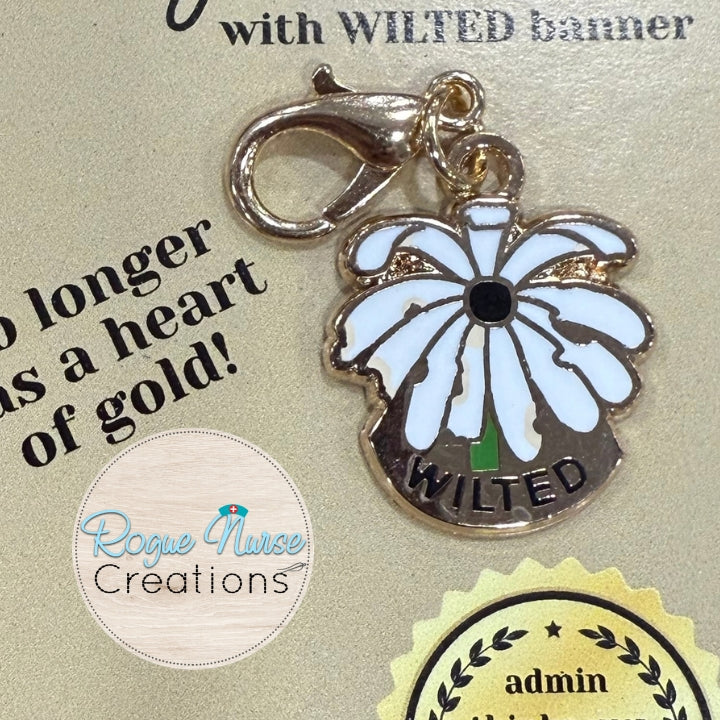 The WILTED Daisy Enamel Badge Charm For The Ordinary Nurse! BLACK Center With White Petals. WILTED Banner below design.