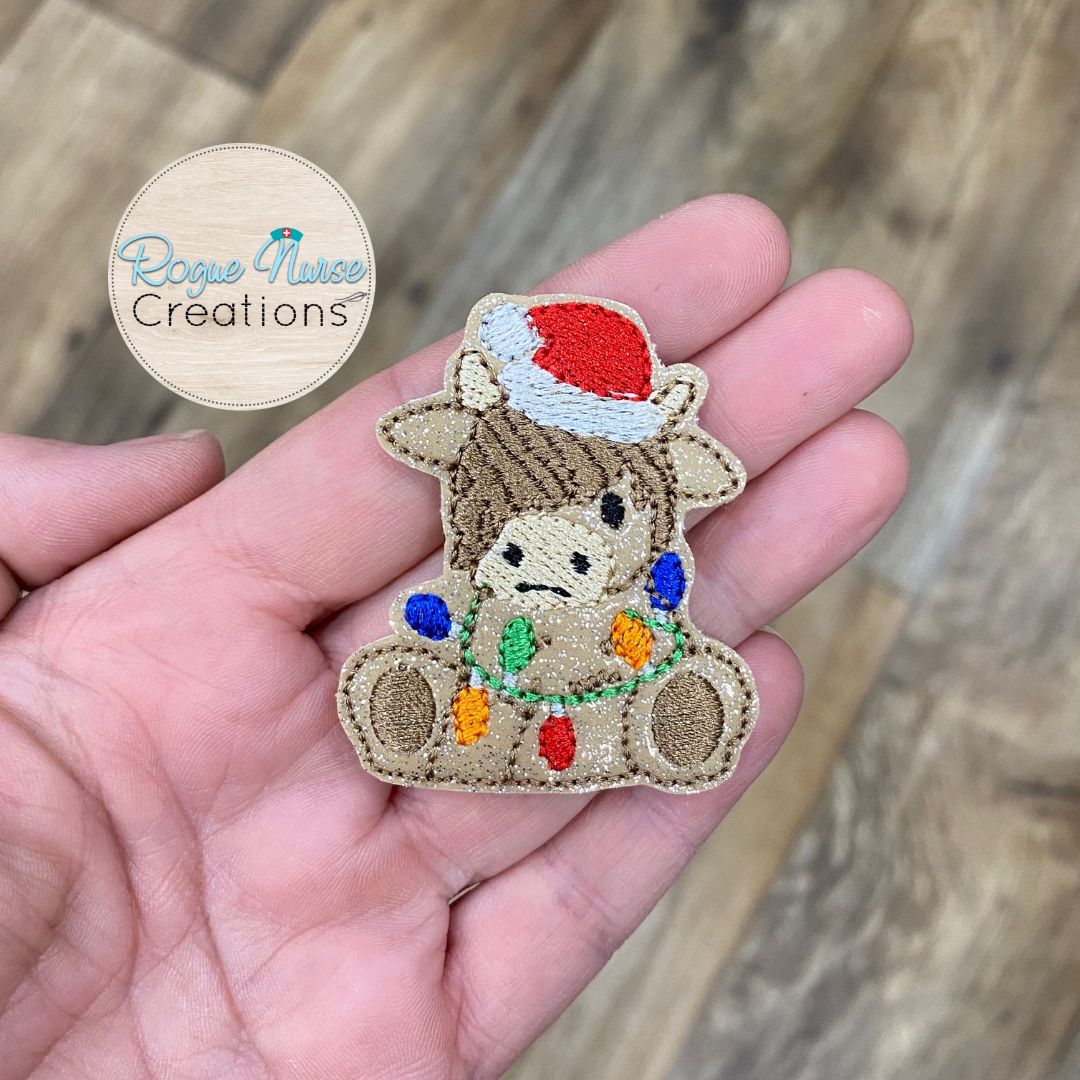 Holiday Highland Cow With a Santa Hat And String of Lights, Embroidered Retractable Badge Reel, Beige Glitter Holiday Cow Badge Reel