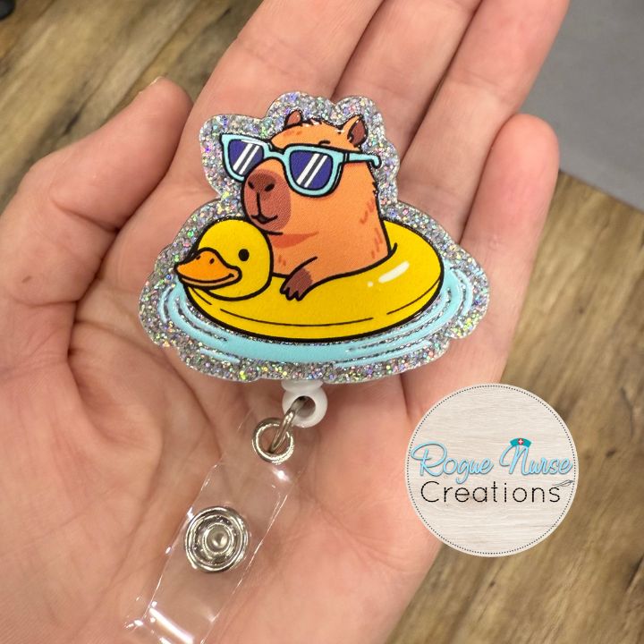 Capybara in a Yellow Duck Floaty Retractable Badge Reel, UV Printed on Silver Glitter Acrylic