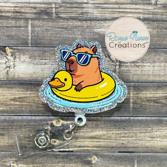 Capybara in a Yellow Duck Floaty Retractable Badge Reel, UV Printed on Silver Glitter Acrylic