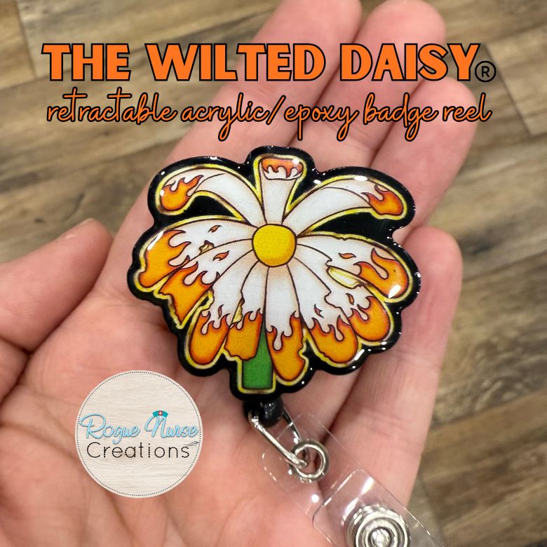 The WILTED Daisy™ Phoenix Edition Acrylic Badge Reel. Original Design With a White Petals with Burning Edge and a Yellow Center.
