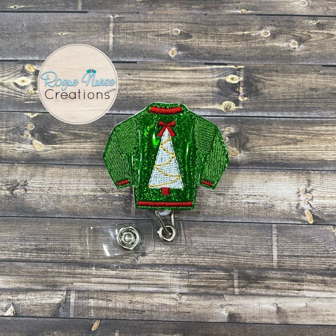 Holiday Sweater Retractable Badge Reel, Matte Red, Glitter Green or Glitter Gold Sweater with a White Holiday Tree and Textured Sleeves.